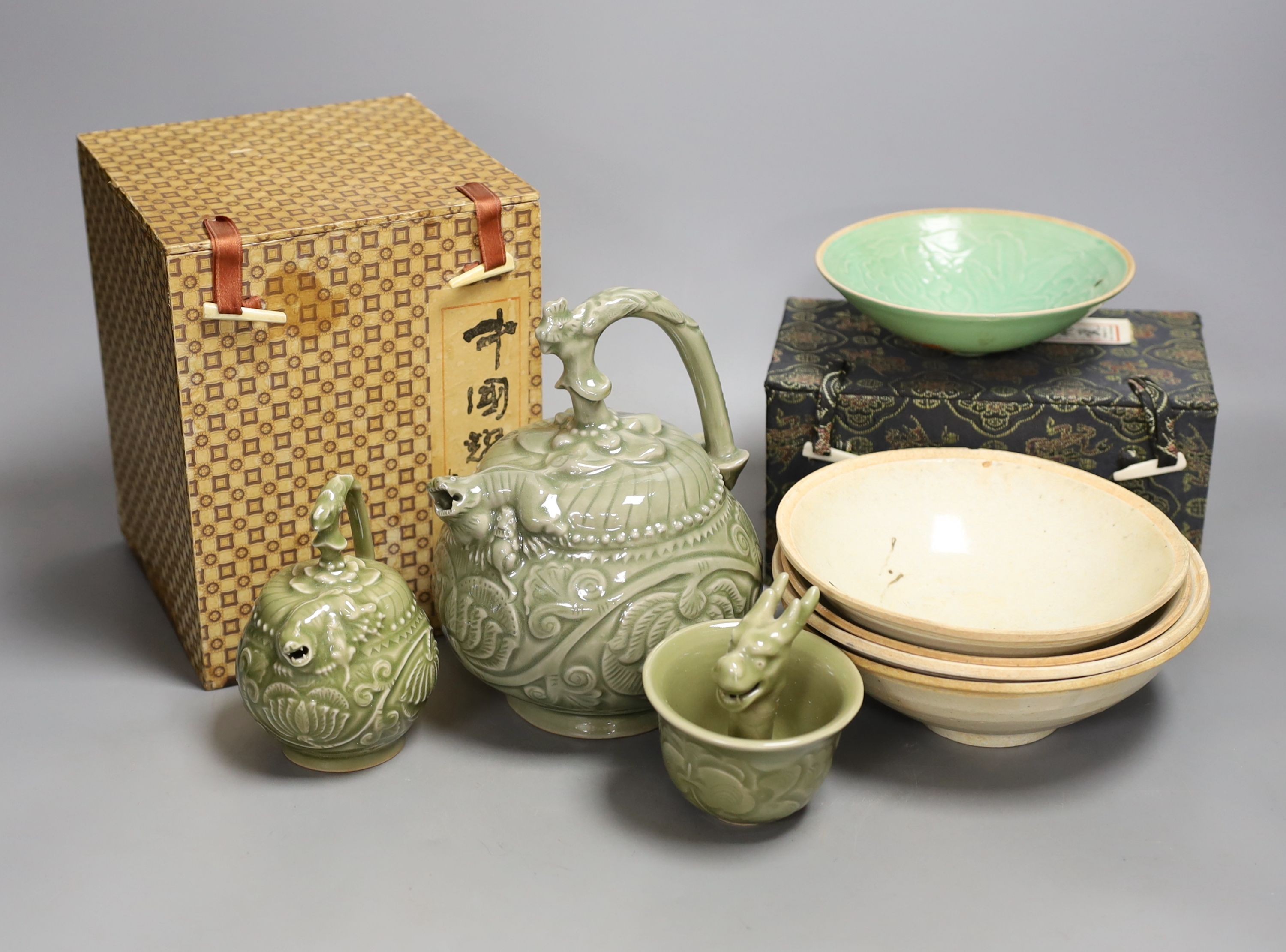 A group of Chinese celadon vessels and Qingbai type bowls, teapot 17 cms high.